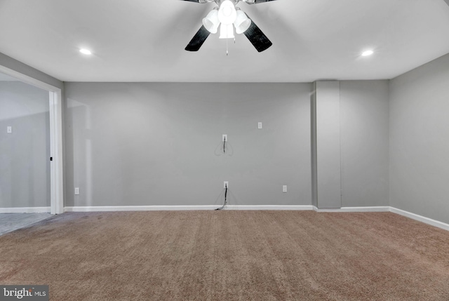 carpeted spare room featuring ceiling fan