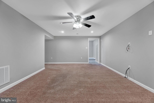 carpeted spare room with ceiling fan