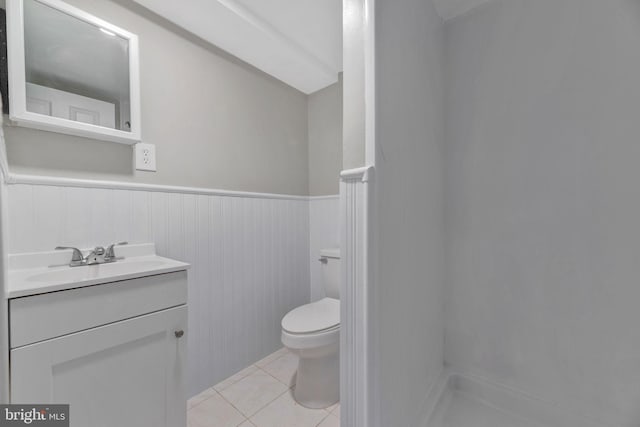 bathroom featuring tile patterned floors, vanity, and toilet