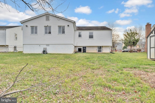 rear view of house with a lawn