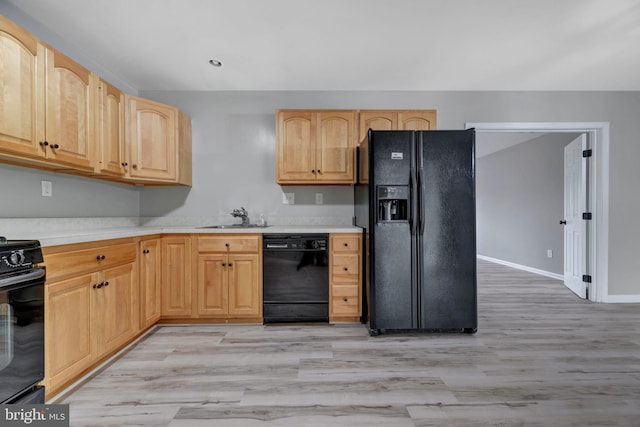 kitchen featuring light brown cabinets, sink, light hardwood / wood-style flooring, and black appliances