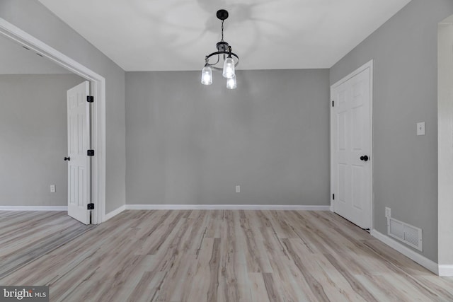 spare room featuring light hardwood / wood-style floors