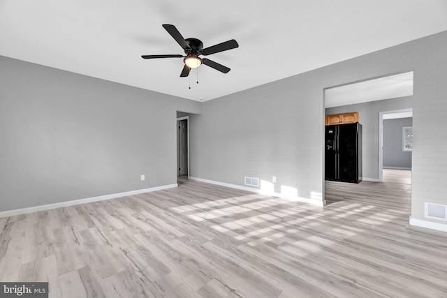 empty room featuring ceiling fan and light wood-type flooring