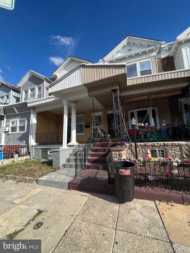 view of property featuring covered porch