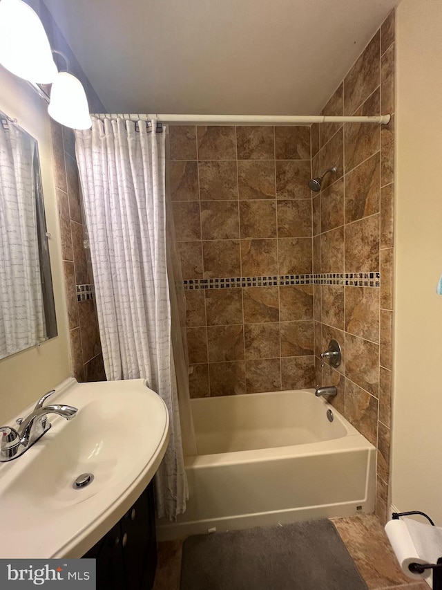 bathroom featuring sink and shower / bathtub combination with curtain