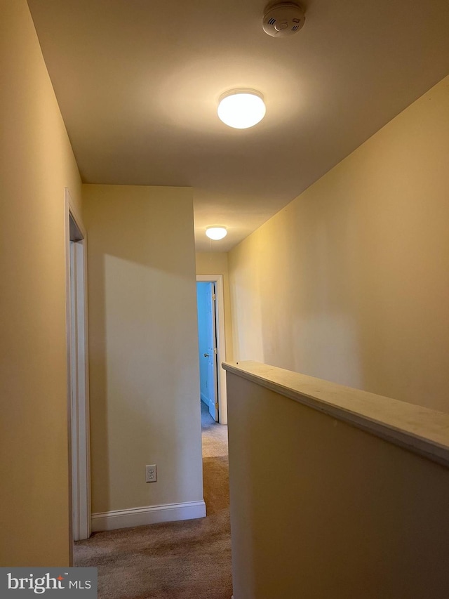 hallway featuring light colored carpet