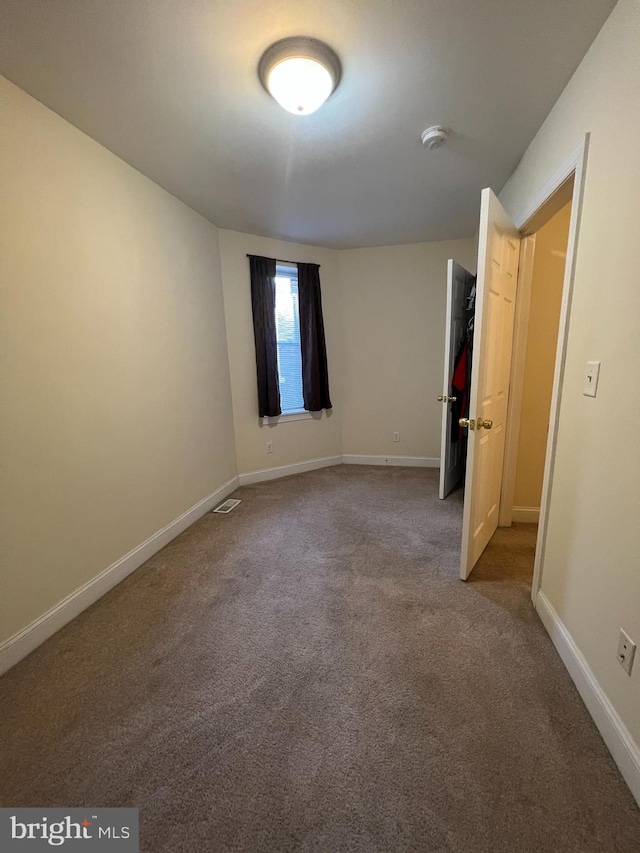 unfurnished bedroom with carpet flooring