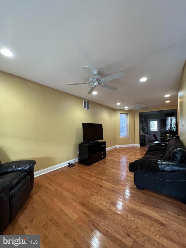 living room with hardwood / wood-style flooring and ceiling fan