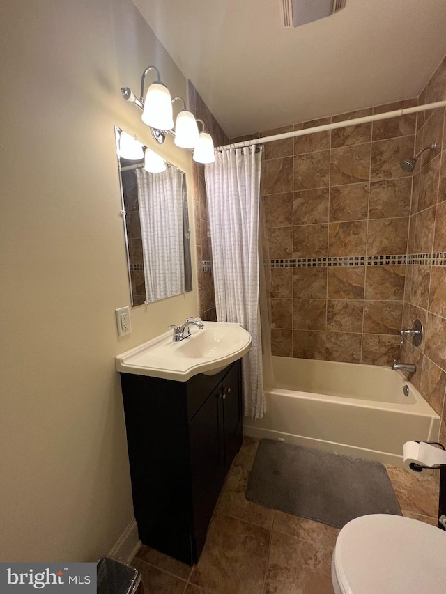 full bathroom with toilet, vanity, shower / bath combo with shower curtain, and tile patterned floors