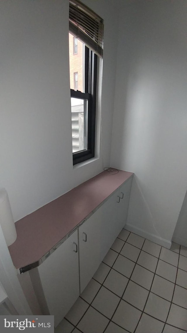 interior space featuring tile patterned floors and baseboards