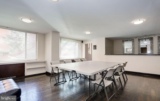 dining space with dark wood-type flooring