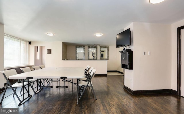 dining area with dark wood finished floors and baseboards