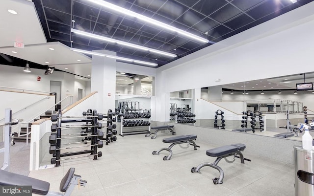 workout area with a high ceiling