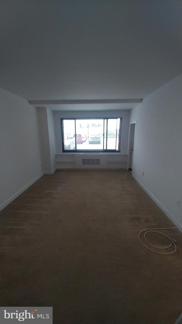 unfurnished room featuring baseboards, visible vents, and carpet floors