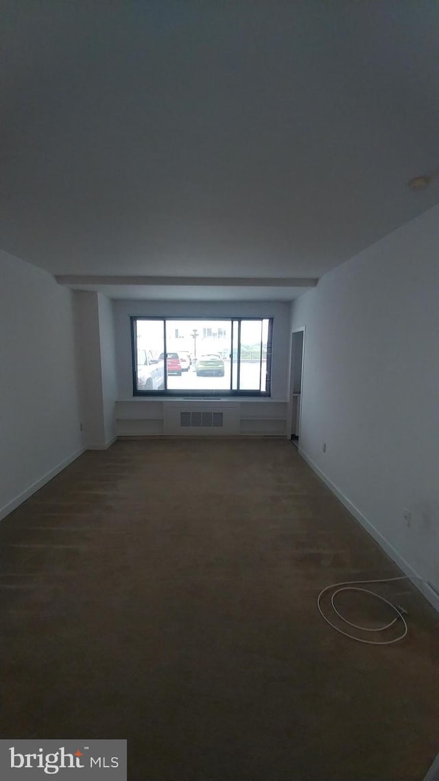unfurnished room featuring visible vents, carpet, and baseboards