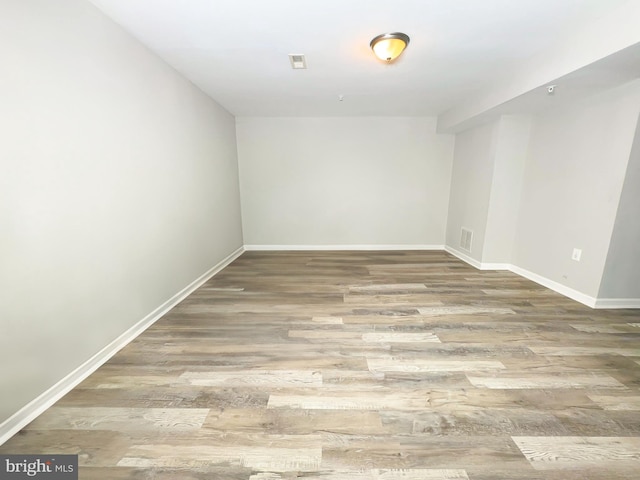 unfurnished room with wood-type flooring