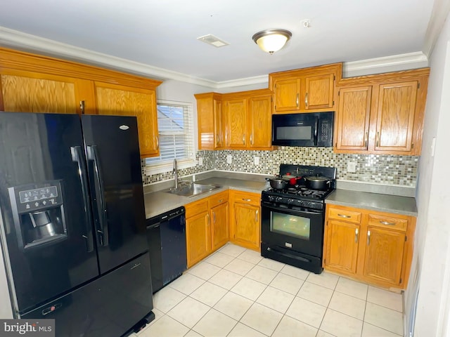 kitchen with ornamental molding, black appliances, decorative backsplash, and sink