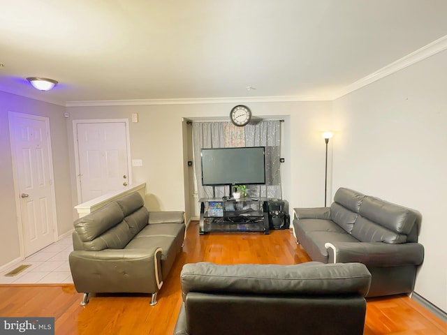 living room with ornamental molding and light wood-type flooring