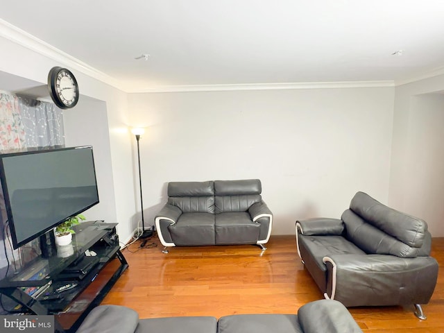 living room with ornamental molding and hardwood / wood-style floors