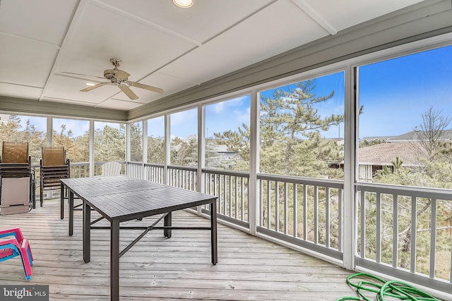 sunroom featuring ceiling fan and plenty of natural light