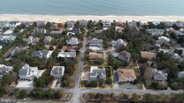 birds eye view of property with a beach view and a water view