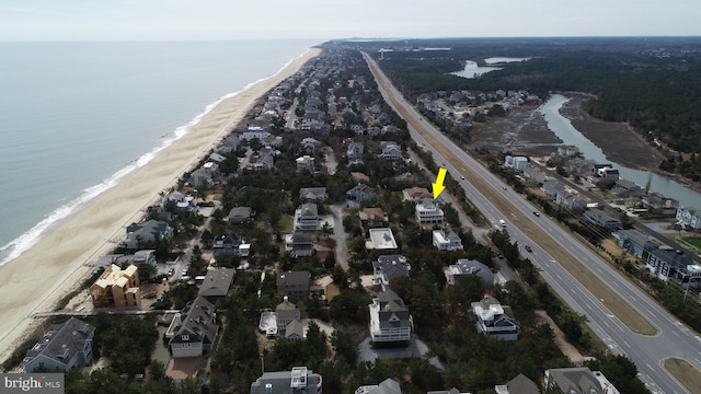 drone / aerial view with a beach view and a water view