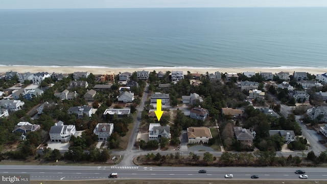 bird's eye view with a water view and a view of the beach