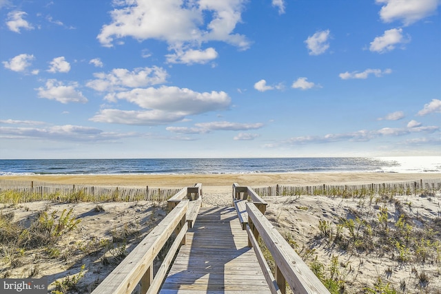 view of property's community with a beach view and a water view