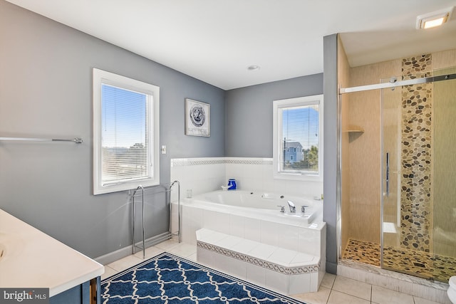 bathroom featuring tile patterned flooring, shower with separate bathtub, and vanity