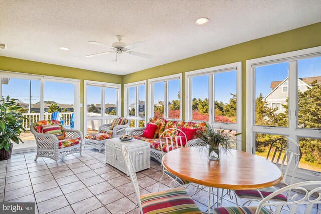 sunroom / solarium featuring ceiling fan and a healthy amount of sunlight