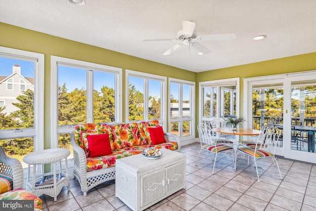 sunroom / solarium with a healthy amount of sunlight and ceiling fan