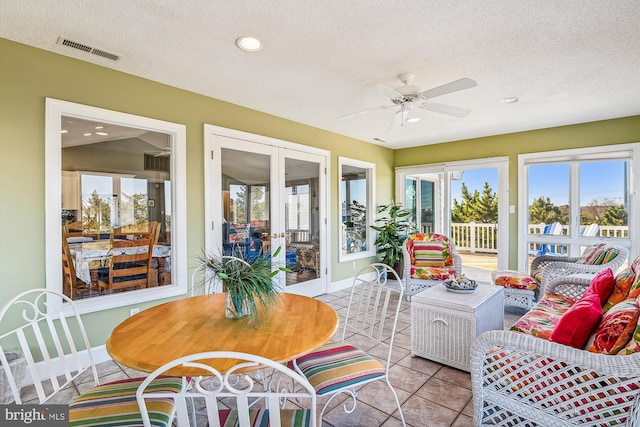 sunroom with ceiling fan and plenty of natural light