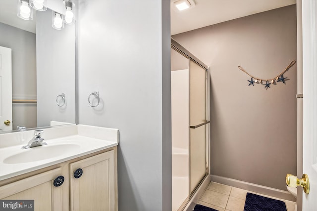 bathroom featuring walk in shower, vanity, and tile patterned floors