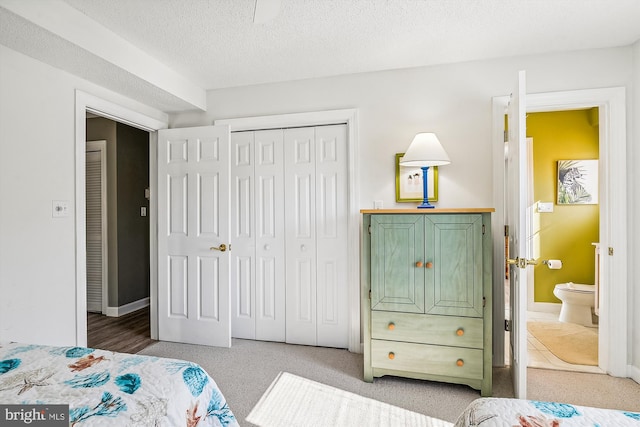 bedroom featuring a closet, a textured ceiling, and ensuite bathroom