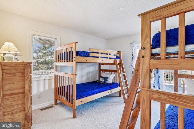 bedroom with multiple windows and carpet flooring