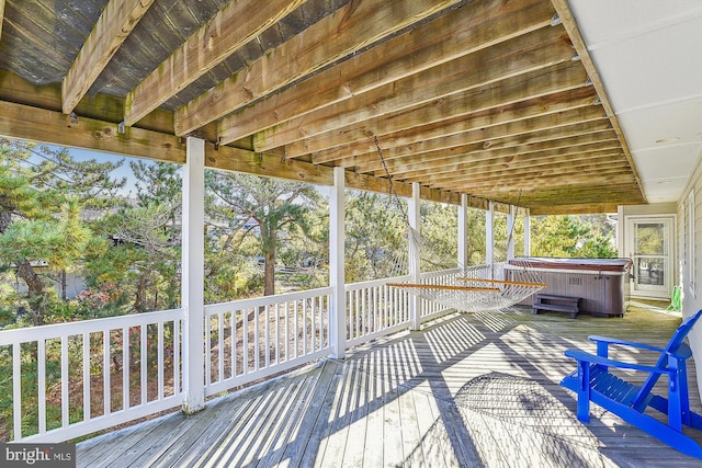 wooden deck with a hot tub