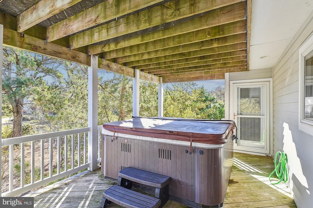 wooden deck with a hot tub