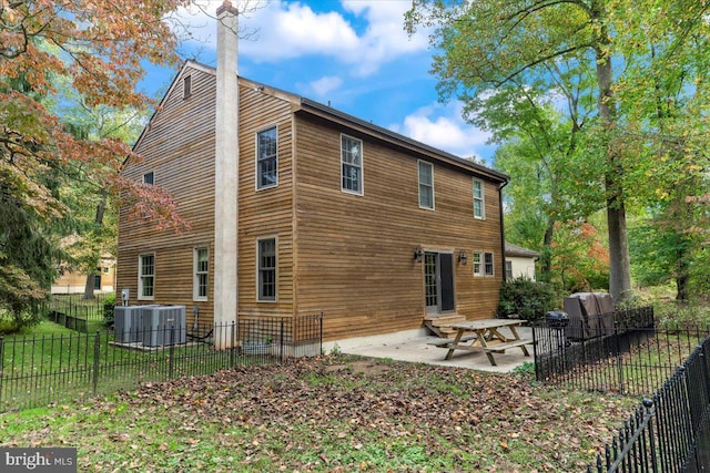 rear view of house featuring a yard and a patio