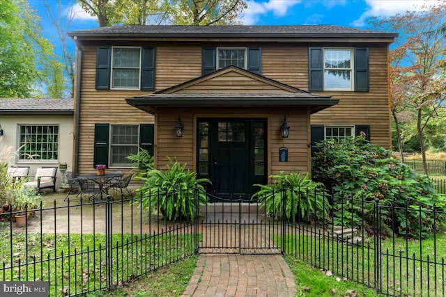 view of front of house featuring a patio area and a front yard