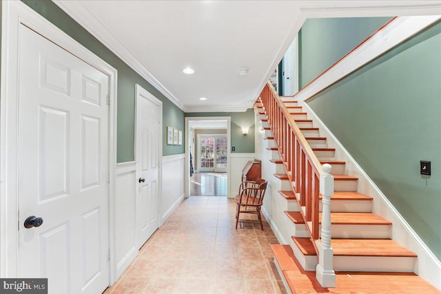 tiled foyer entrance with ornamental molding