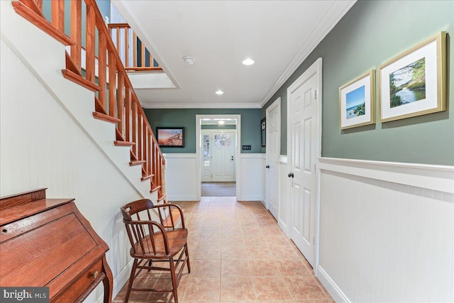 corridor with ornamental molding and light tile patterned floors