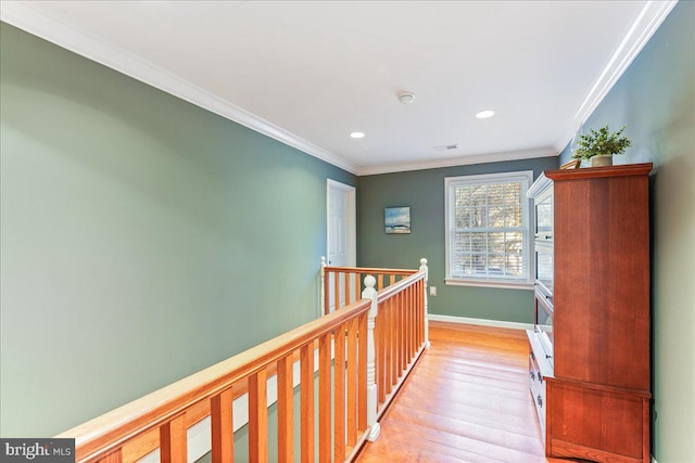 hall with light hardwood / wood-style flooring and crown molding