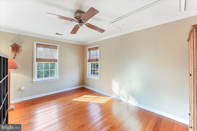 empty room with light hardwood / wood-style floors, ornamental molding, and ceiling fan