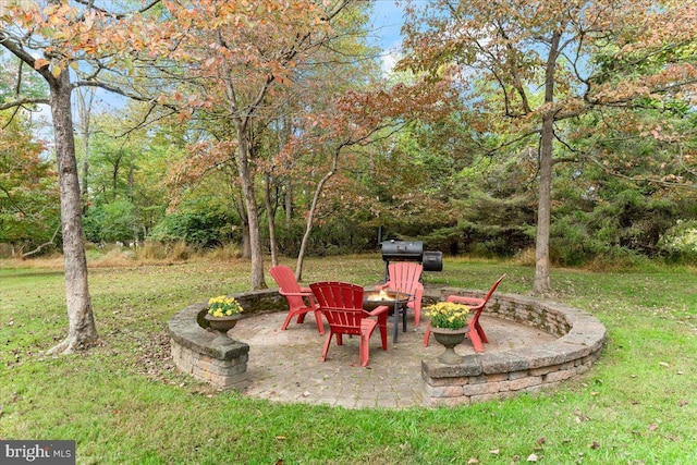 view of yard featuring an outdoor fire pit and a patio