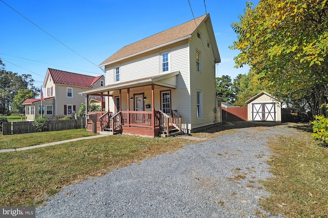 view of front of home featuring a storage unit, a front lawn, and a porch