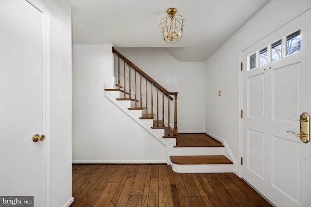 entrance foyer featuring dark hardwood / wood-style floors and a chandelier