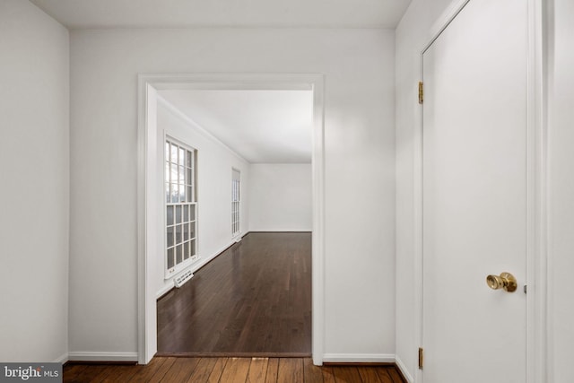 corridor featuring dark hardwood / wood-style flooring