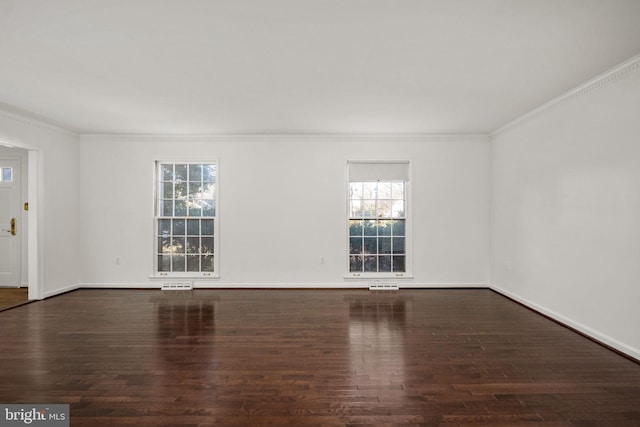 spare room with crown molding and dark wood-type flooring