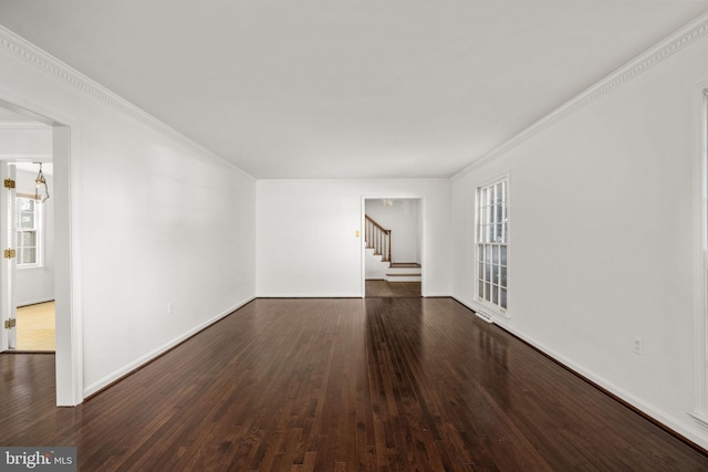 empty room featuring crown molding, a chandelier, and dark hardwood / wood-style floors