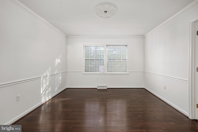 empty room featuring dark hardwood / wood-style flooring and crown molding